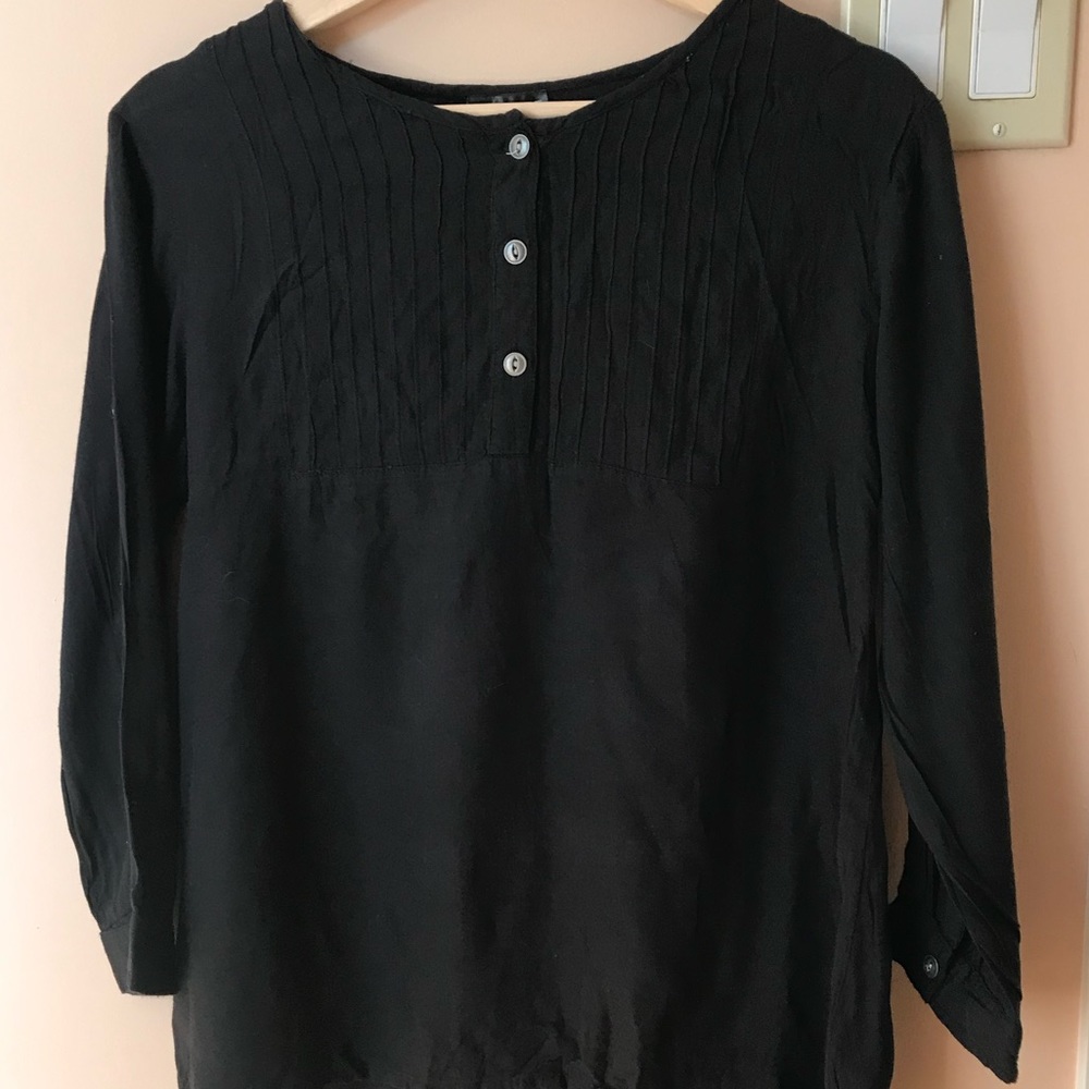 Elegant black blouse with front ribbed detail. Mid chest button down.